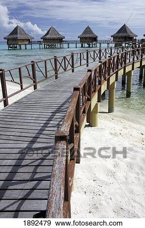 Stock Photo - Walkway To Holiday Huts Over Lagoon. Fotosearch