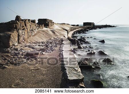 Stock Image - Wall And Pier Along The Coast; Barbate Cadiz Andalusia Spain. Fotosearch