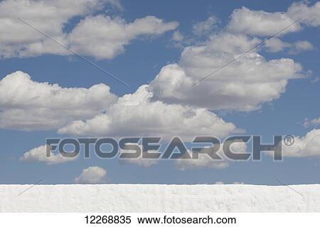 Wall of snow with puffy clouds and blue sky above, Park City, Utah, USA View Large Photo Image Stock Photography - Wall of snow with puffy clouds and blue sky above, Park City, Utah, USA. Fotosearch