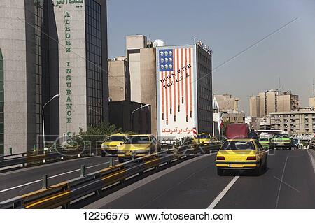 Stock Photography - Wall portrait 'Down with the USA' beside expressway, Central Tehran; Tehran, Iran. Fotosearch
