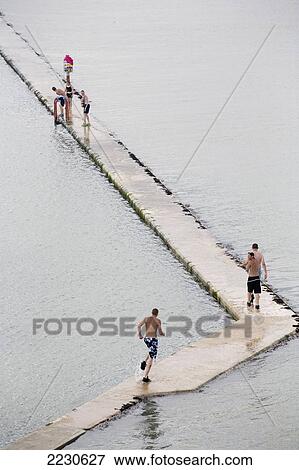 Stock Photo - Walpole Bay, saltwater pool, Margate, Kent, UK Local kids dive from the manmade wall of the saltwater pool which is only visible an hour each side of high tide. Fotosearch