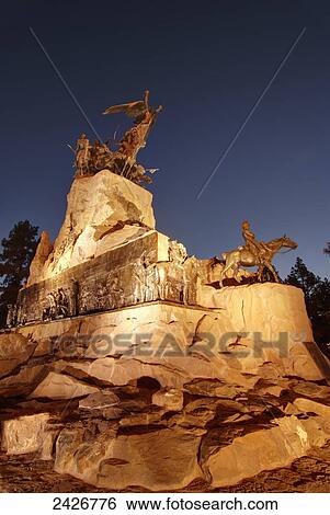 Stock Photograph - War monument at night in golden light; Mendoza, Argentina. Fotosearch