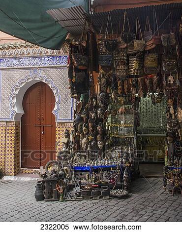 Wares for sale displayed in market stall beside house entrance; Medina, Marrakech, Morocco View Large Photo Image Stock Photography - Wares for sale displayed in market stall beside house entrance; Medina, Marrakech, Morocco. Fotosearch