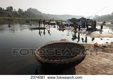 Washing and cleaning clothes in the river; Hampi, Karnataka, India View Large Photo Image Stock Image - Washing and cleaning clothes in the river; Hampi, Karnataka, India. Fotosearch
