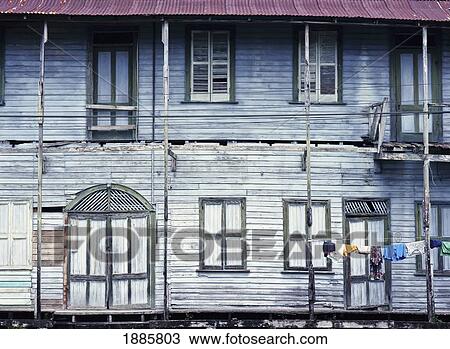 Stock Image - Washing Drying On An Old Wooden House. Fotosearch
