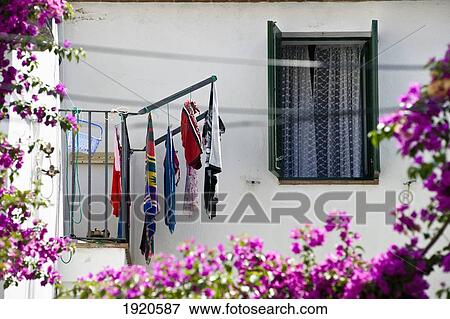 Stock Photo - Washing Drying On Lines Outside Window. Fotosearch