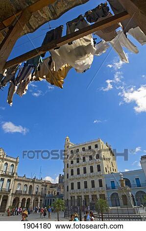 Stock Image - Washing Drying Under Building Roof With Plaza Vieja In Background, Havana, Cuba. Fotosearch