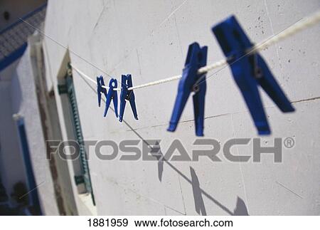 Washing Line Against House With Blue Clothes Pins View Large Photo Image Stock Photo - Washing Line Against House With Blue Clothes Pins. Fotosearch