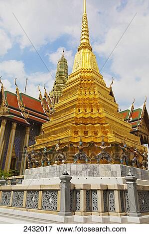 Wat Phra Kaeo Temple, Royal Palace, Caryatid demonds on a golden chedi, Grand Palace; Bangkok, Thailand View Large Photo Image Stock Photo - Wat Phra Kaeo Temple, Royal Palace, Caryatid demonds on a golden chedi, Grand Palace; Bangkok, Thailand. Fotosearch
