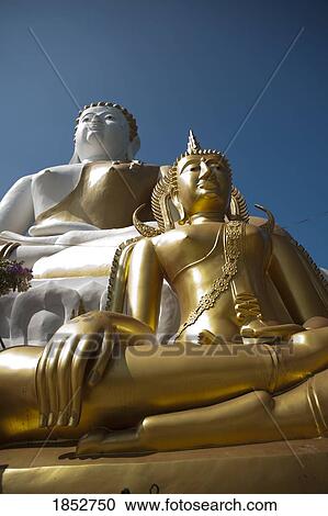 Stock Image - Wat Phrathat Doi Kham Temple Statues, Chiang Mai, Thailand. Fotosearch