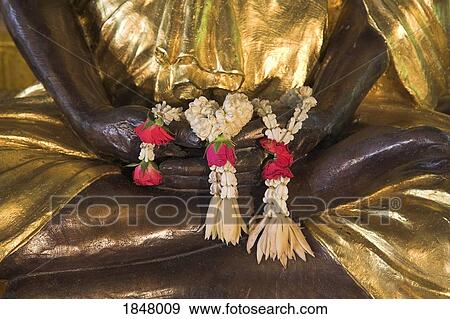 Wat Somdej Phuttachan, Thailand; Close-Up Of Flowered Leis Over Hand Of Buddhist Statue View Large Photo Image Stock Photo - Wat Somdej Phuttachan, Thailand; Close-Up Of Flowered Leis Over Hand Of Buddhist Statue. Fotosearch