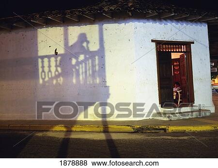 Stock Photo - Watching The Street And Watching Television, Liberia At Night. Fotosearch