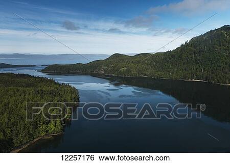 Stock Photograph - Water and dense forests around the Charlotte Islands; Skeena-Queen Charlotte, British Columbia, Canada. Fotosearch