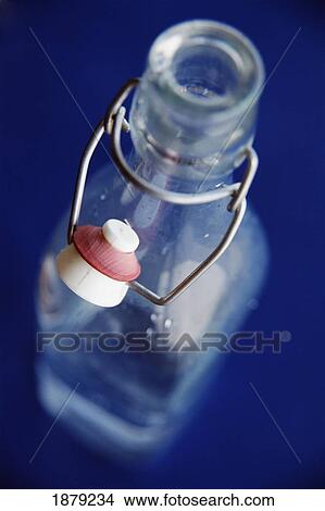 Picture - Water Bottle On A Blue Table. Fotosearch