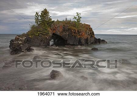 Stock Image - Water Coming Into Shore Around A Rock Formation On Lake Superior; Grand Portage, Minnesota, United States Of America. Fotosearch