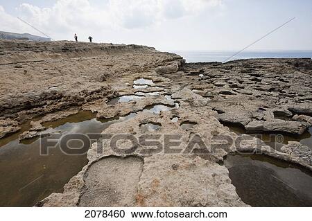 Water-Filled Holes Of The Inland Sea, Dwejra Bay, Gozo Island, Malta View Large Photo Image Stock Image - Water-Filled Holes Of The Inland Sea, Dwejra Bay, Gozo Island, Malta. Fotosearch