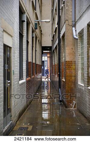 Water on the ground in an alleyway between buildings, Soho; London, England View Large Photo Image Picture - Water on the ground in an alleyway between buildings, Soho; London, England. Fotosearch
