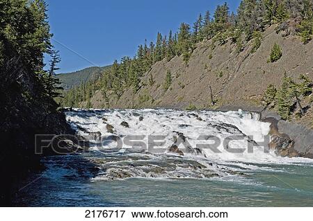 Stock Photo - Water Rushing Over Rocky Falls; Alberta Canada. Fotosearch