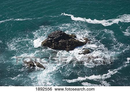 Stock Photograph - Water Splashing On Rock, Elevated View. Fotosearch