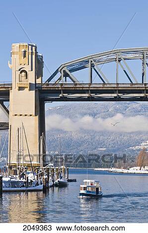 Stock Image - Water Taxi Going Under Burrard Street Bridge, Vancouver, British Columbia. Fotosearch