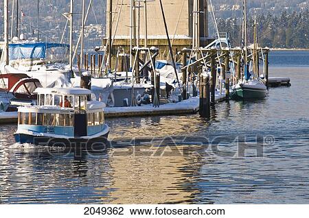 Stock Image - Water Taxi Passing A Harbour After Snow Fall, Vancouver, British Columbia. Fotosearch