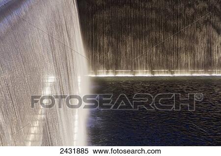 Stock Photography - Waterfalls and reflecting pools of the National September 11 Memorial at night, New York City, New York, United States. Fotosearch