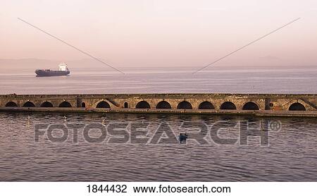 Stock Image - Waterfront Promenade, Boat In Background; Naples, Italy. Fotosearch
