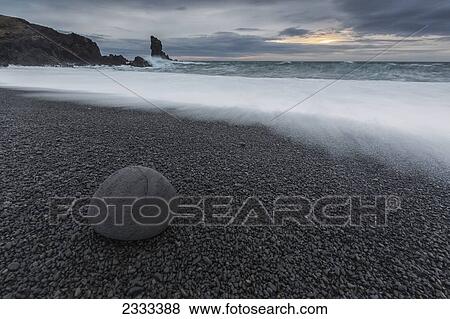 Stock Photo - Wave Crashing On The Rocky Beach Of Djupalon; Snaefellsnes Peninsula, Iceland. Fotosearch