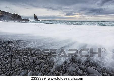 Wave Crashing On The Rocky Beach Of Djupalon; Snaefellsnes Peninsula, Iceland View Large Photo Image Stock Photo - Wave Crashing On The Rocky Beach Of Djupalon; Snaefellsnes Peninsula, Iceland. Fotosearch