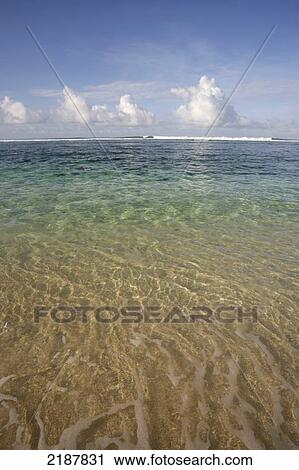 Stock Image - Wave rolling in at a distance on the ocean; Mauritius. Fotosearch