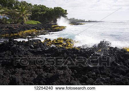 Stock Image - Waves crash into the shore at Isaac Hale Park on the Big Island of Hawaii; Island of Hawaii, Hawaii, United States of America. Fotosearch