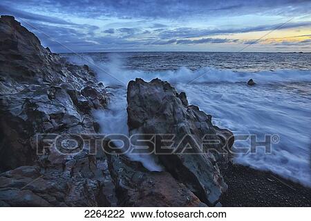 Stock Image - Waves crash over the shoreline along the beach of djupalonssandur; iceland. Fotosearch