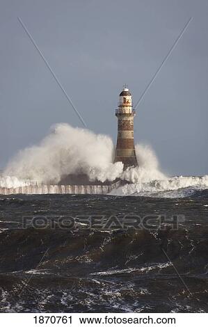Waves Crashing Against A Lighthouse; Sunderland, Tyne And Wear, England View Large Photo Image Stock Image - Waves Crashing Against A Lighthouse; Sunderland, Tyne And Wear, England. Fotosearch