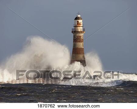 Waves Crashing Against A Lighthouse; Sunderland, Tyne And Wear, England View Large Photo Image Stock Image - Waves Crashing Against A Lighthouse; Sunderland, Tyne And Wear, England. Fotosearch