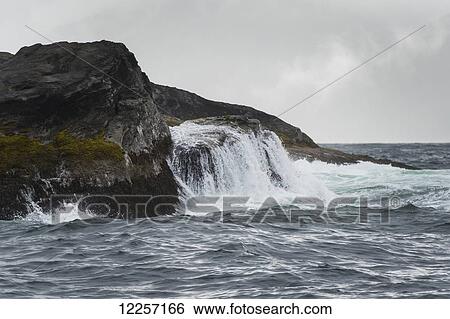 Waves crashing against the rugged shore under a cloudy sky; Skeena-Queen Charlotte, British Columbia, Canada View Large Photo Image Stock Photograph - Waves crashing against the rugged shore under a cloudy sky; Skeena-Queen Charlotte, British Columbia, Canada. Fotosearch