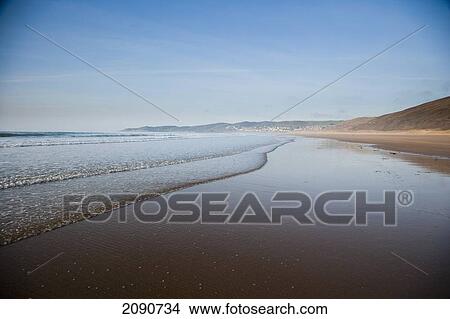 Picture - Waves Lapping On The Sandy Beach, On A Calm Sunny Day At Putsborough Sands, North Devon, Uk. Fotosearch