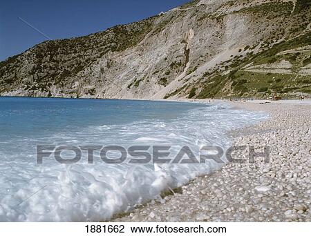 Stock Image - Waves On Pebbled Beach, Myrtos Beach, Close Up. Fotosearch