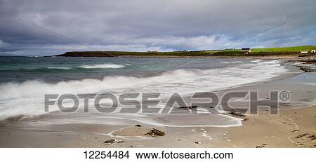 Waves splashing into the shore and a view of the coastline, Aikerness Bay; Orkney, Scotland View Large Photo Image Picture - Waves splashing into the shore and a view of the coastline, Aikerness Bay; Orkney, Scotland. Fotosearch