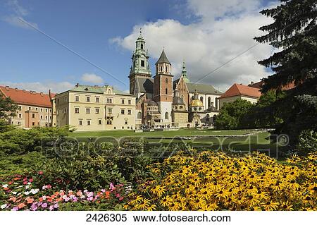 Stock Photography - Wawel Hill, Krakow Cathedral, medieval building foundations in front of the Cathedral, with colourful flowers in the foreground; Krakow, Poland. Fotosearch