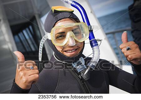Stock Photograph - Wearing Dive Gear And Getting Ready For A Dolphin Swim; Kaikoura, New Zealand. Fotosearch