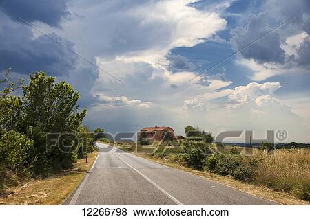Stock Photo - Weather rolls into the Tuscan countryside; Sinalunga, Val D'Orcia, Tuscany, Italy. Fotosearch