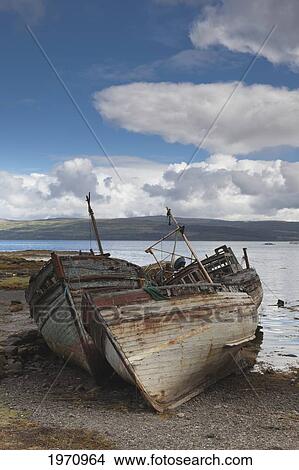 Picture - Weathered Boats Abandoned At The Water's Edge; Salem Isle Of Mull Scotland. Fotosearch