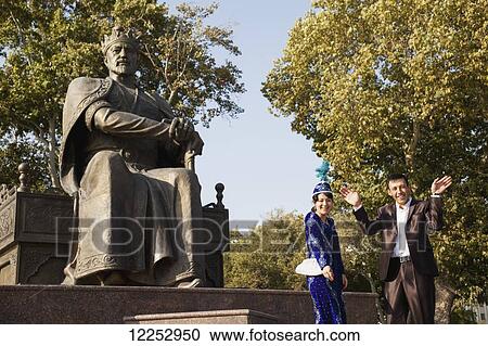 Stock Image - Wedding couple at Amir Timur statue; Samarkand, Uzbekistan. Fotosearch