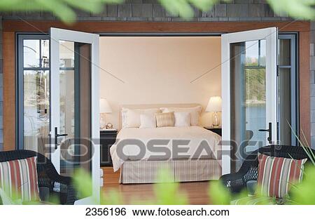 Stock Photograph - West Coast Home Bedroom With Ocean View; Mayne Island, British Columbia, Canada. Fotosearch