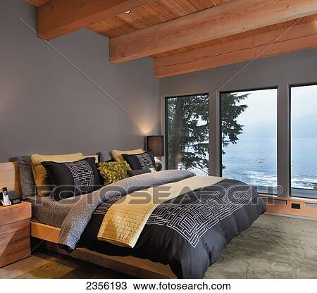Stock Image - West Coast Home Master Bedroom With Ocean View; Port Renfrew, Vancouver Island, British Columbia, Canada. Fotosearch