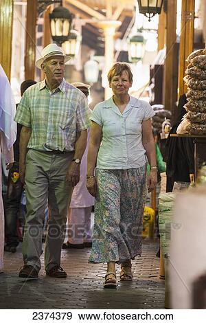 Stock Photo - Western couple walking through the spice souk; Dubai, United Arab Emirates. Fotosearch