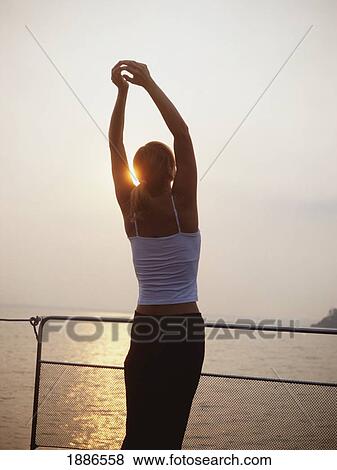 Stock Photo - Western Woman Doing Yoga On A Cruise Boat. Fotosearch
