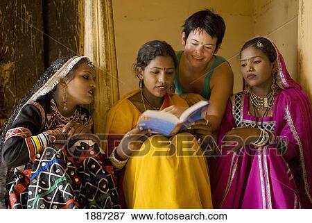 Westerner And Women In Saris And Jewellery Looking At Guide Book View Large Photo Image Stock Photo - Westerner And Women In Saris And Jewellery Looking At Guide Book. Fotosearch