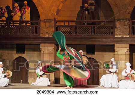 Picture - Whirling Dervish Performing A Sufi Dance At The Al-Ghouri Mausoleum At Night, Cairo, Al Qahirah, Egypt. Fotosearch