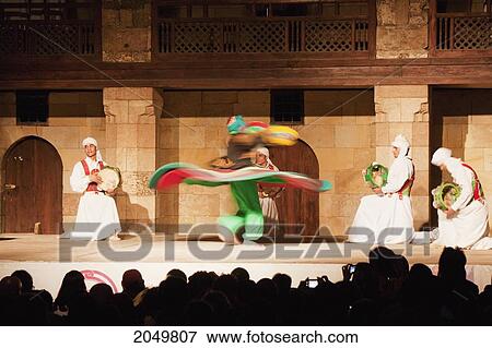 Stock Photo - Whirling Dervish Performing A Sufi Dance At The Al-Ghouri Mausoleum At Night, Cairo, Al Qahirah, Egypt. Fotosearch